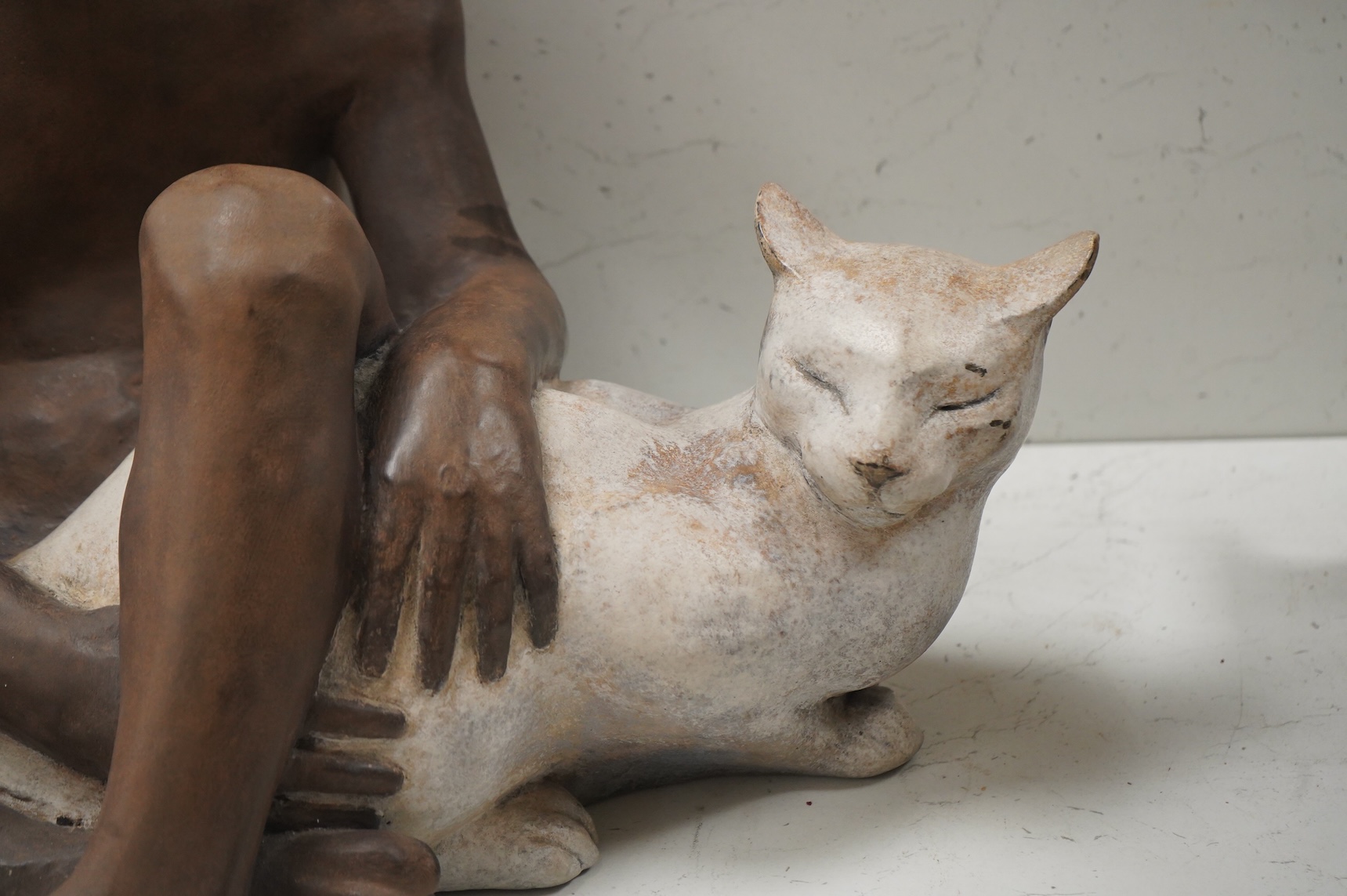 A contemporary composition figure of a seated boy and a cat, 46cm